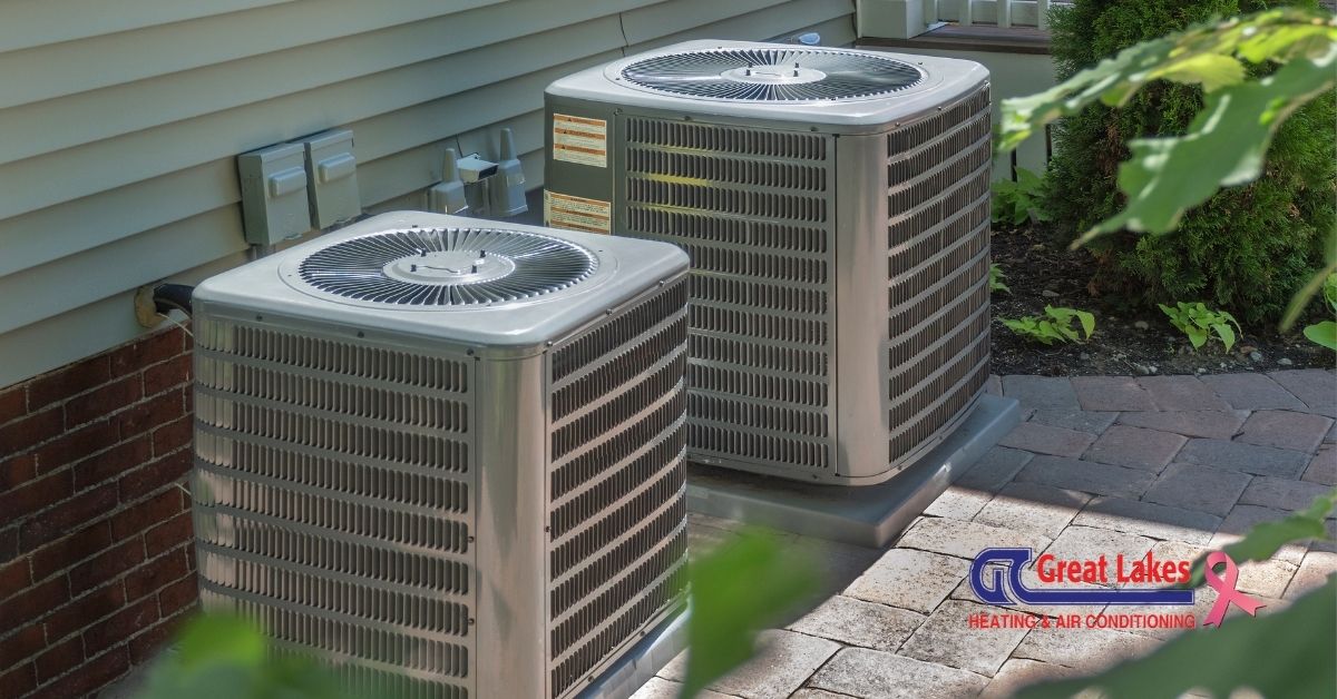 Two air conditioning condensers next to a building